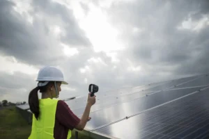 A solar installer Long Island inspecting rooftop solar panels with professional testing equipment under cloudy skies.